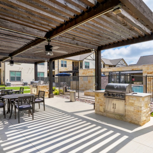 Outdoor Grilling Area with Seating under Pergola
