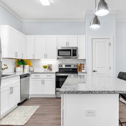Model kitchen at Retreat at Krum senior living apartments in Krum, TX, featuring stainless steel appliances.