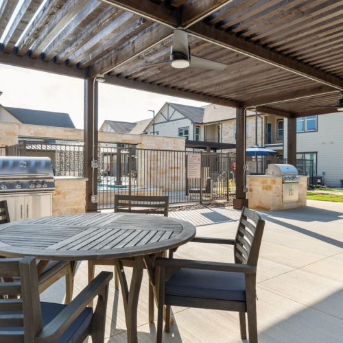 Outdoor Grilling Area with Seating under Pergola
