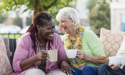 Senior ladies laughing and drinking coffee