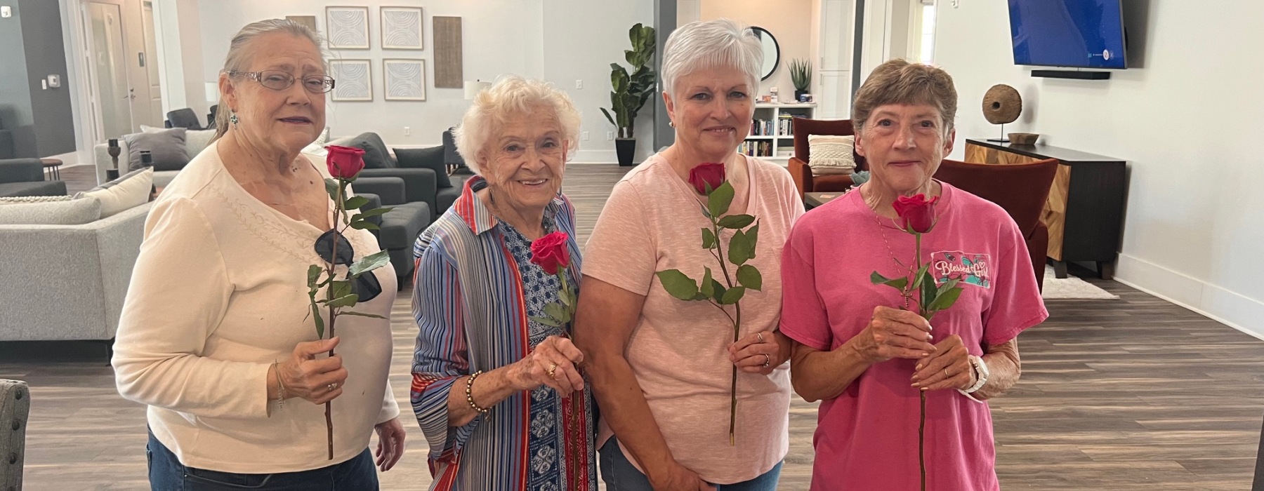4 senior ladies with roses at a Mother's Day breakfast